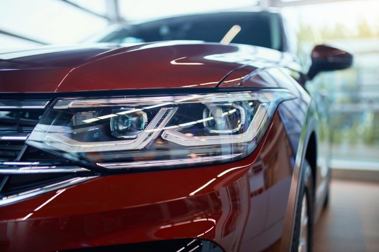 close-up-headlamp-expensive-red-car-showroom_7502-9567